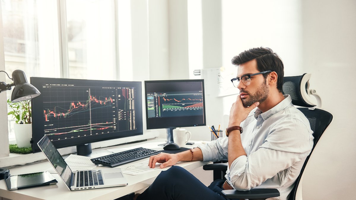 Investor checking stock market on computer.