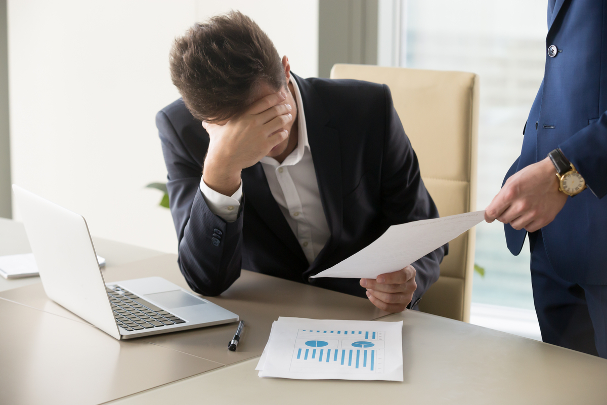 Man receiving bad news from someone at work.