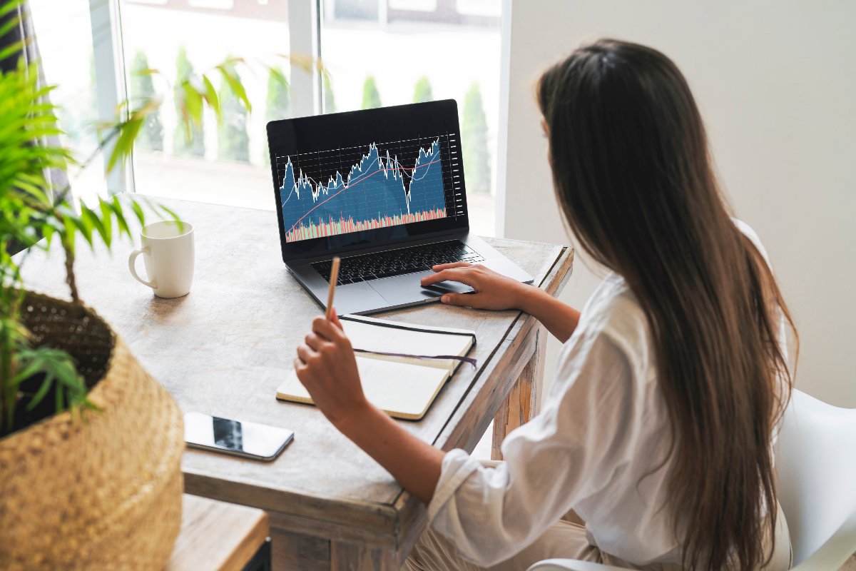 Investor monitoring stock on laptop.