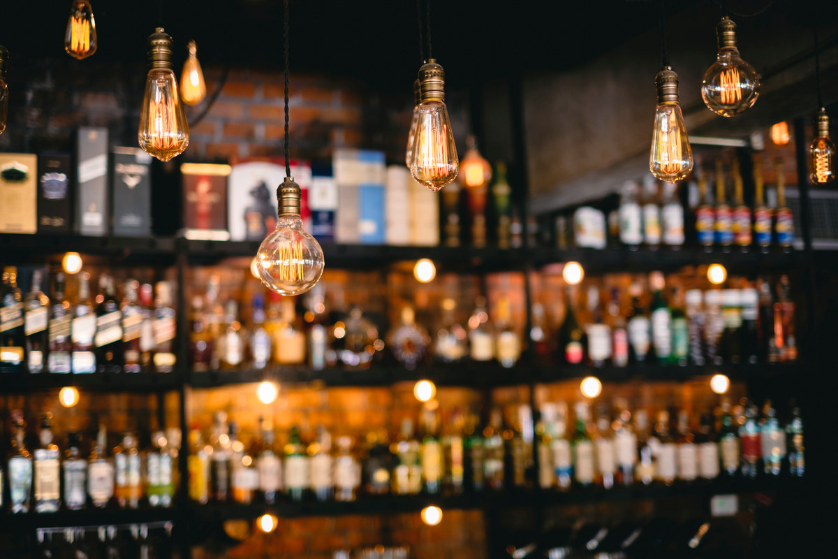 Bottles behind a bar counter.