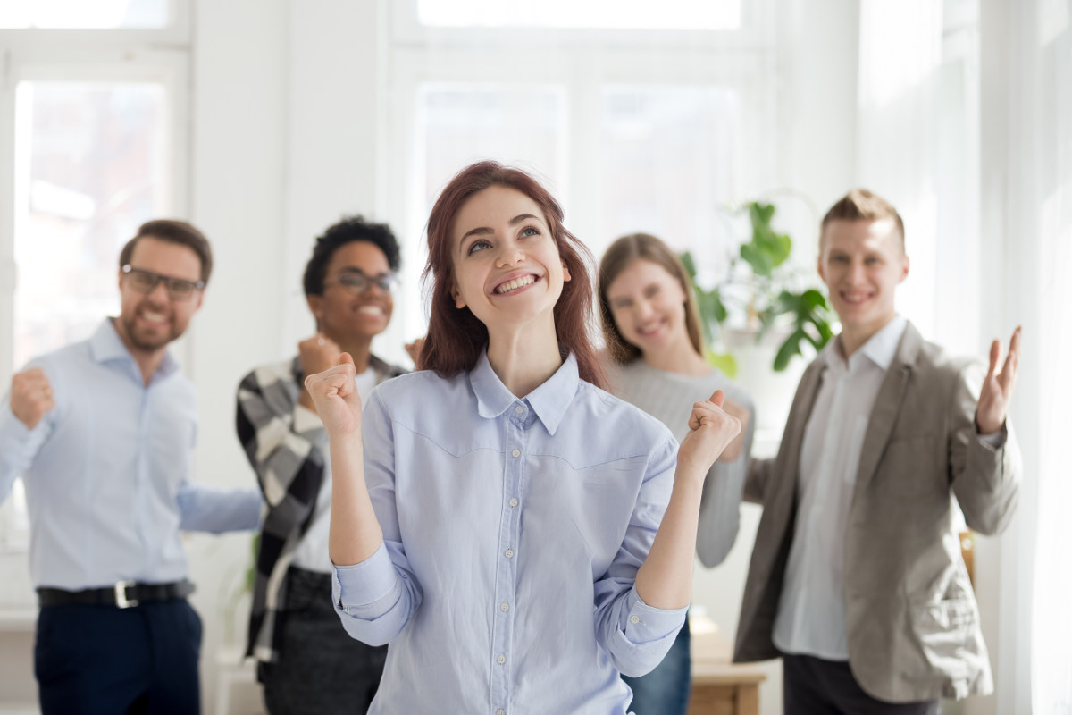 Group of employees celebrating a business victory.