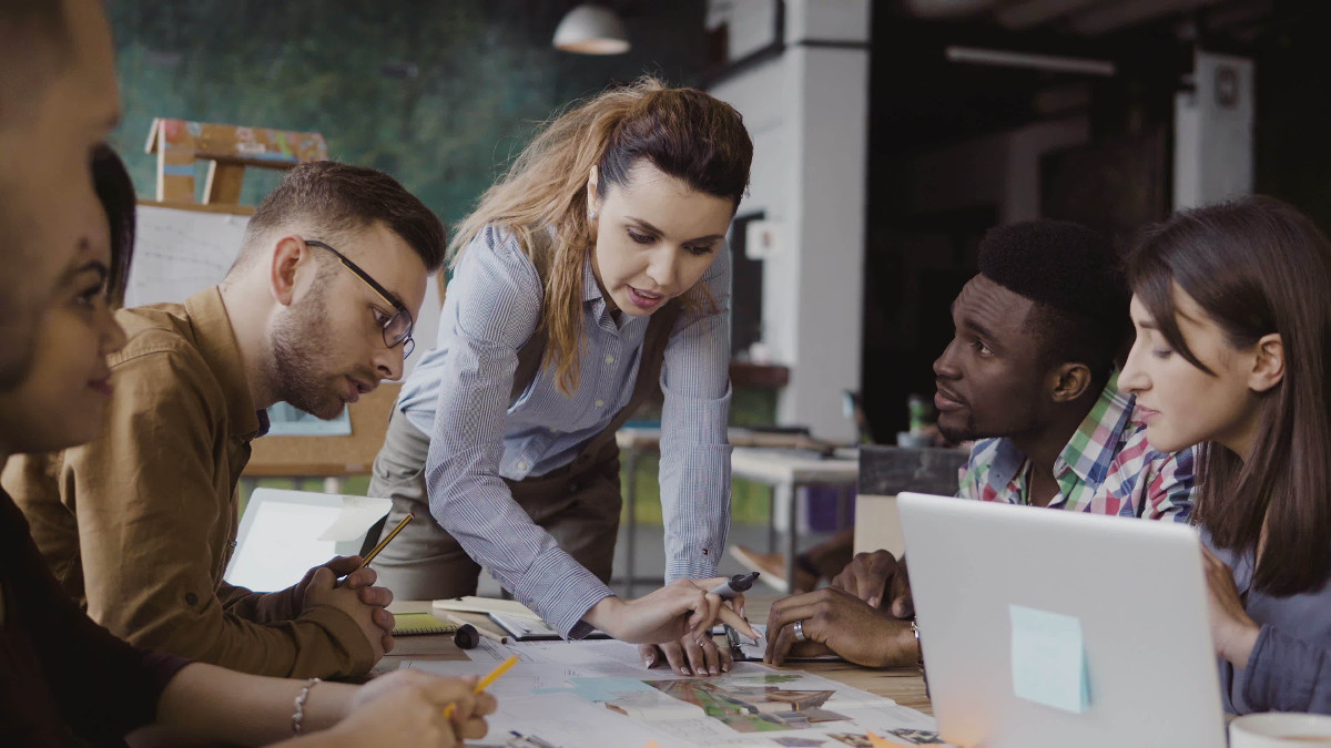 Employees working around a conference table.