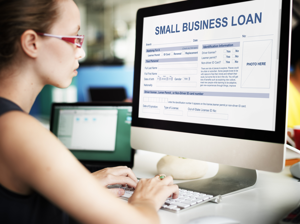 Woman looking at a business loan application on her computer.