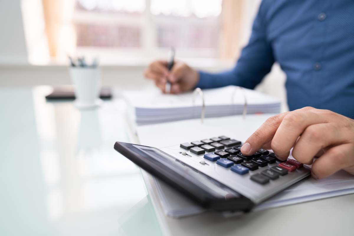 Man working out a business debt calculation.