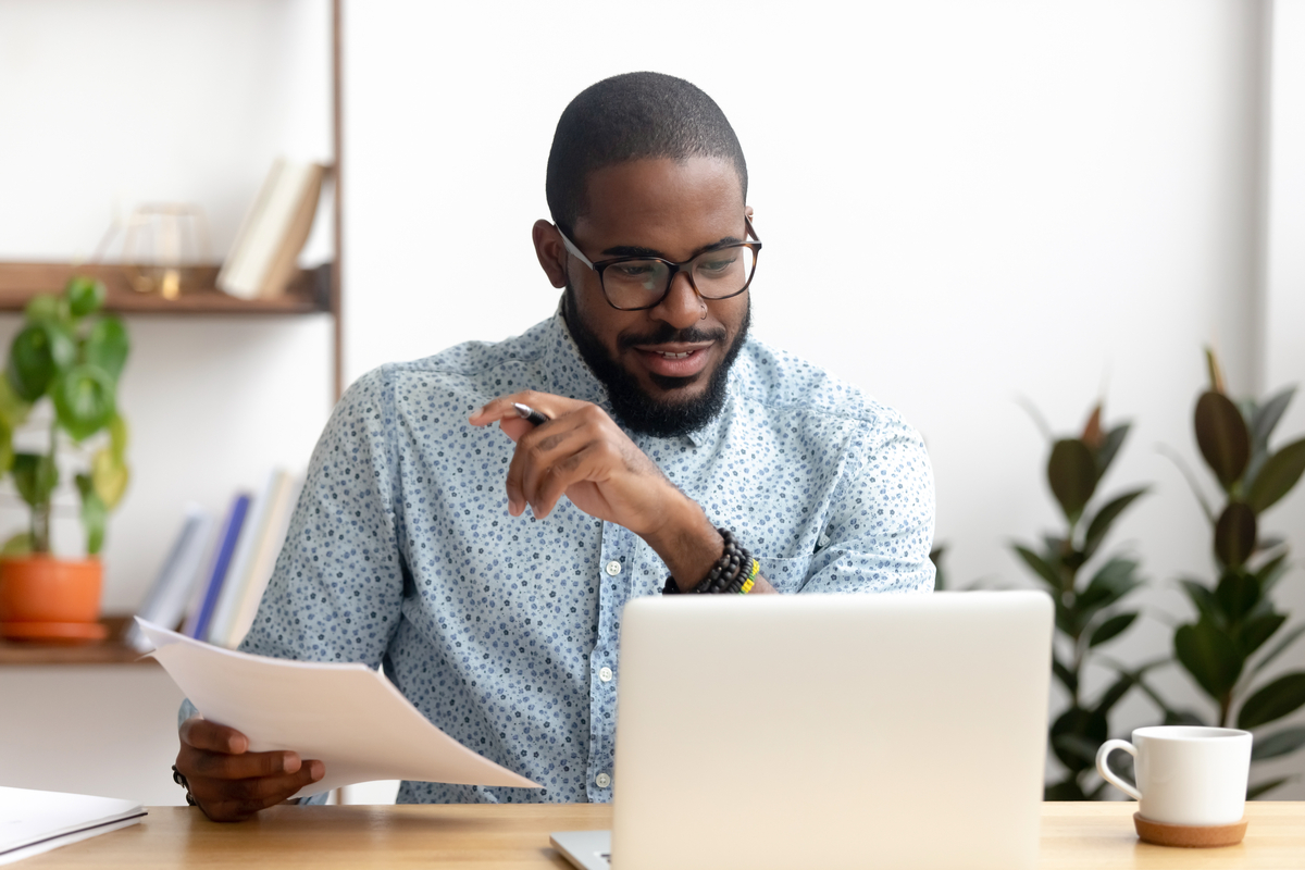 Man looking at account numbers for his business.