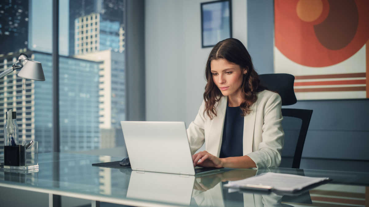 Female CEO working at desk on laptop