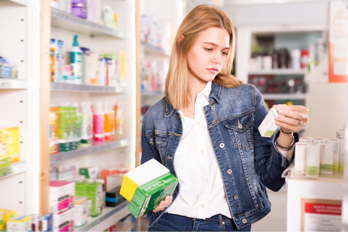Young adult choosing between products.