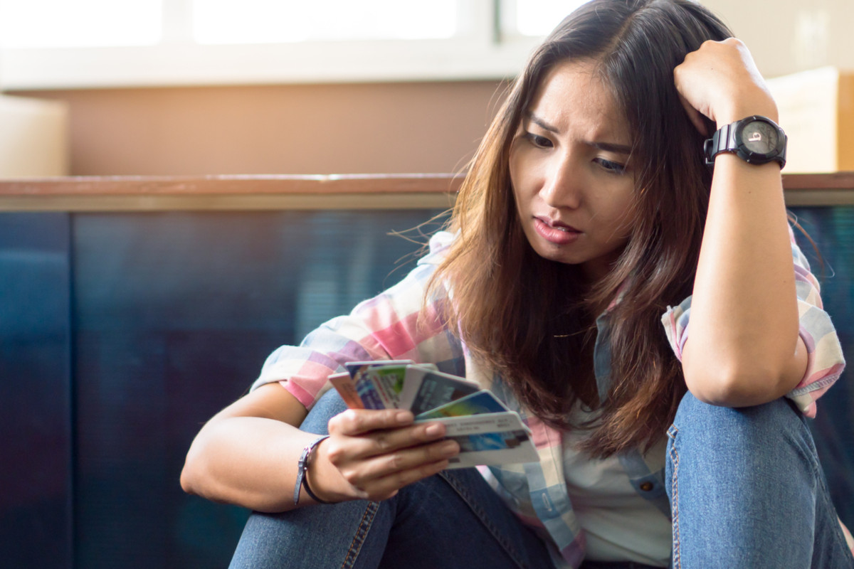 A woman who is distraught by her credit card debt.