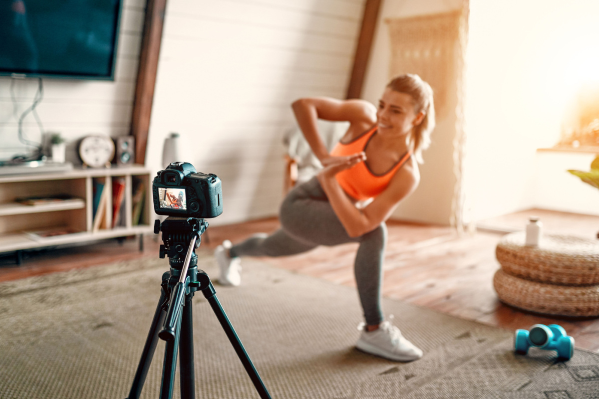 Fitness influencer filming workout video