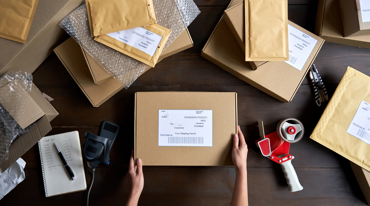 Man preparing boxes for free shipping.