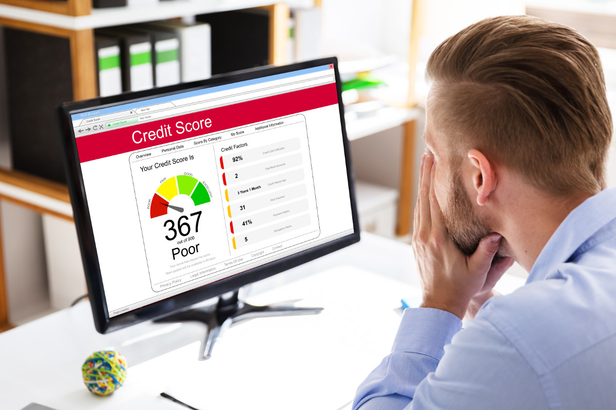 Business professional reviewing credit score at work.