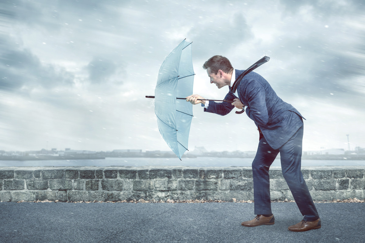 Man presses against wind.