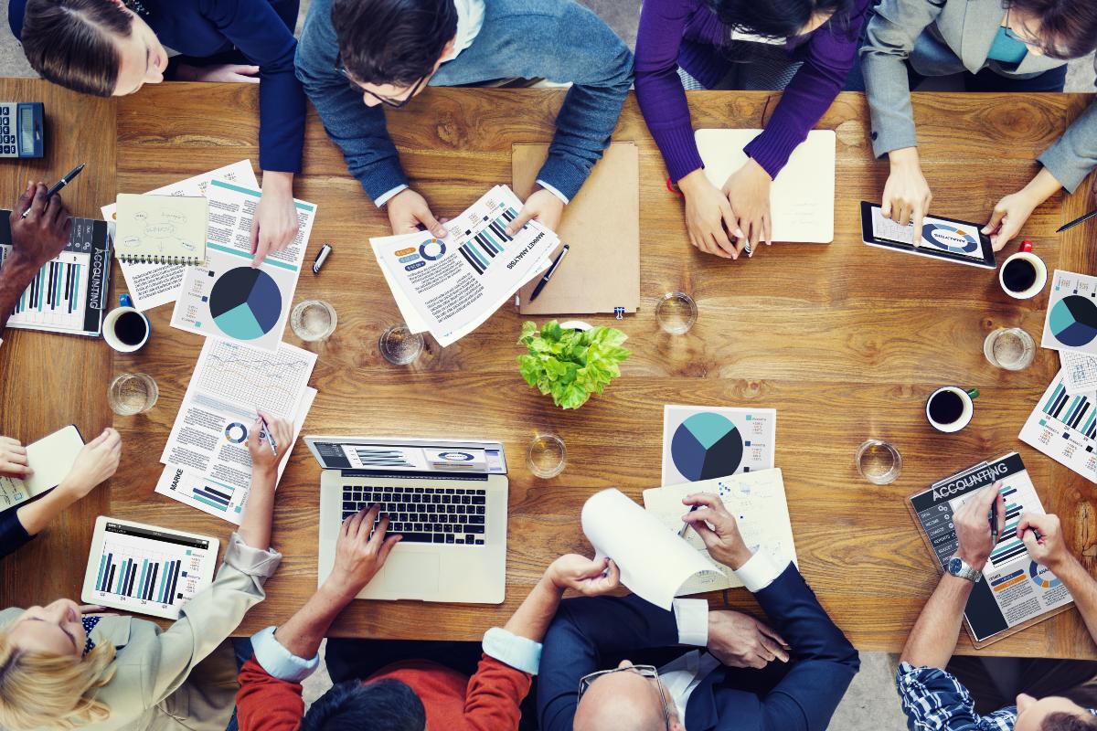 Overhead view of professional marketing meeting.