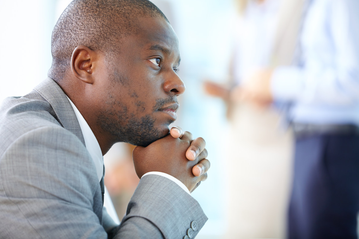 Businessperson sitting and thinking.