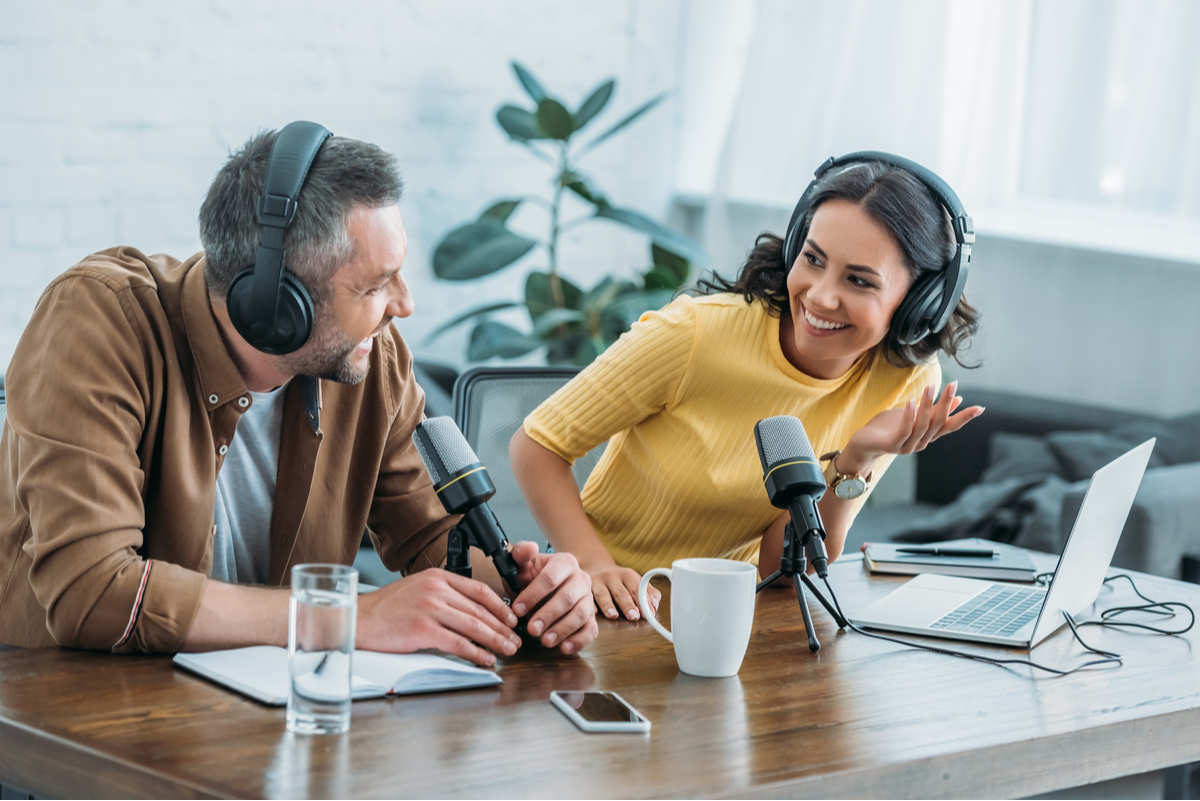 Man and woman participating in a podcast.