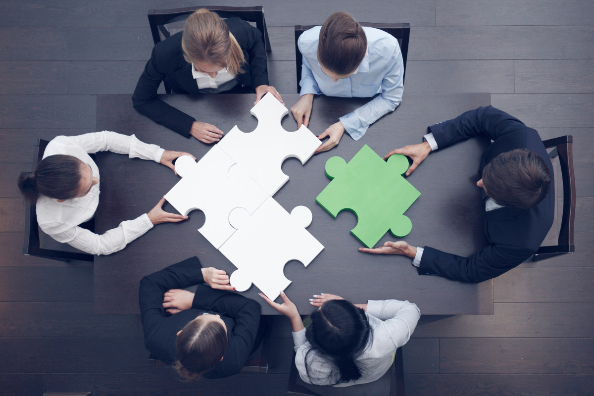 Group of employees working at a desk.