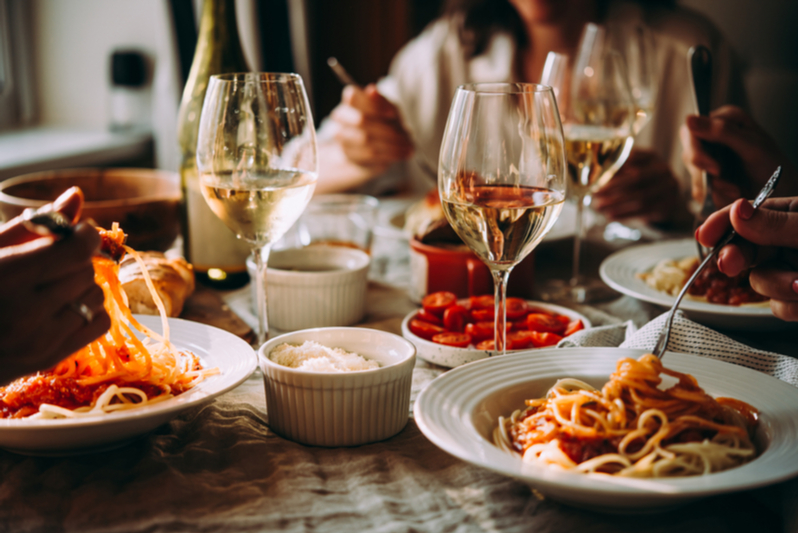 A restaurant table with wine glasses.