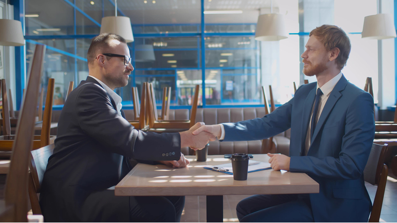 A business agreement being made at a restaurant when it is closed.