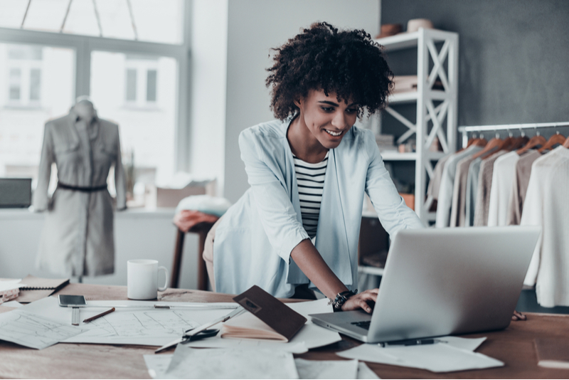 Woman working on laptop in her small business.