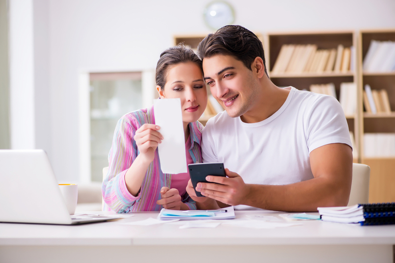 Man and woman calculating their small business savings account.