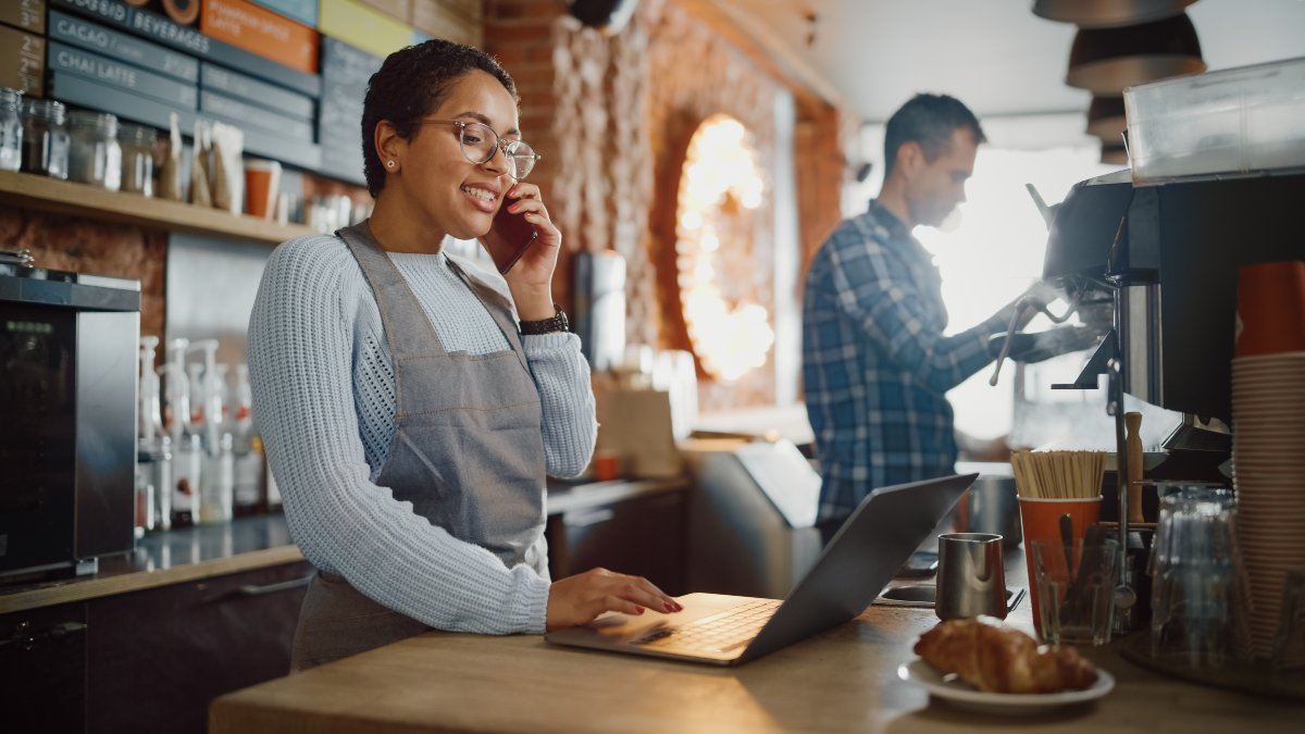 Small business owner on the phone and laptop.