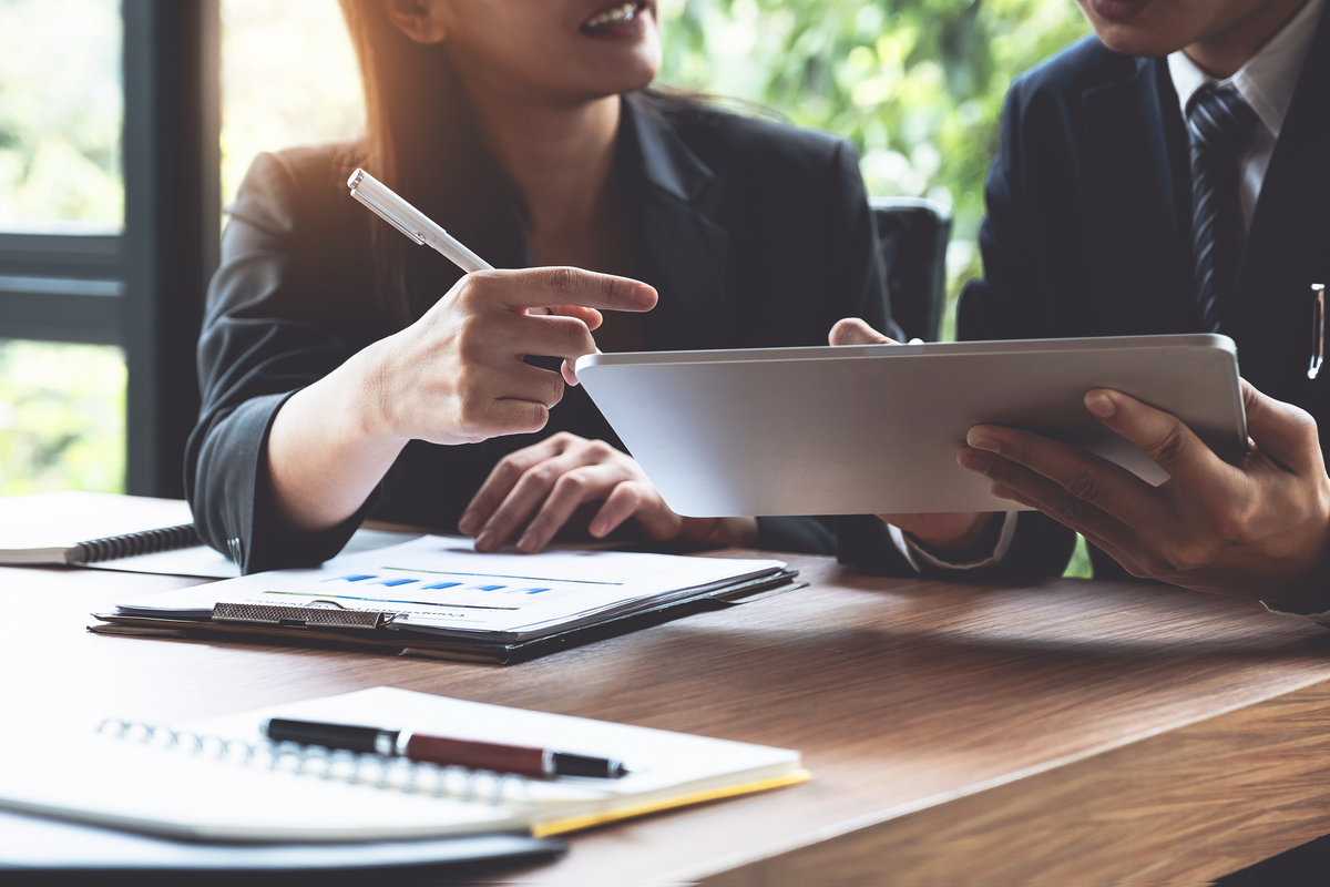 Man and woman looking over business loan information.