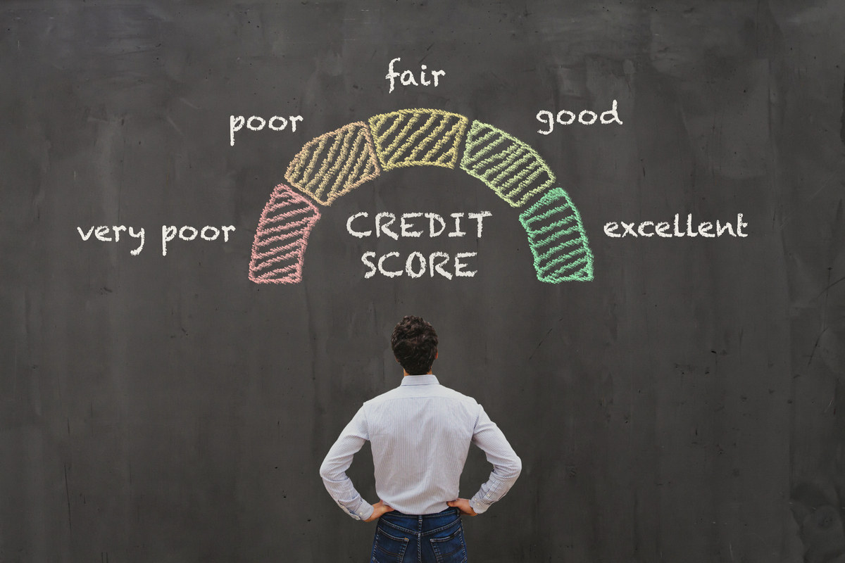 Man contemplating the significance of different credit scores.