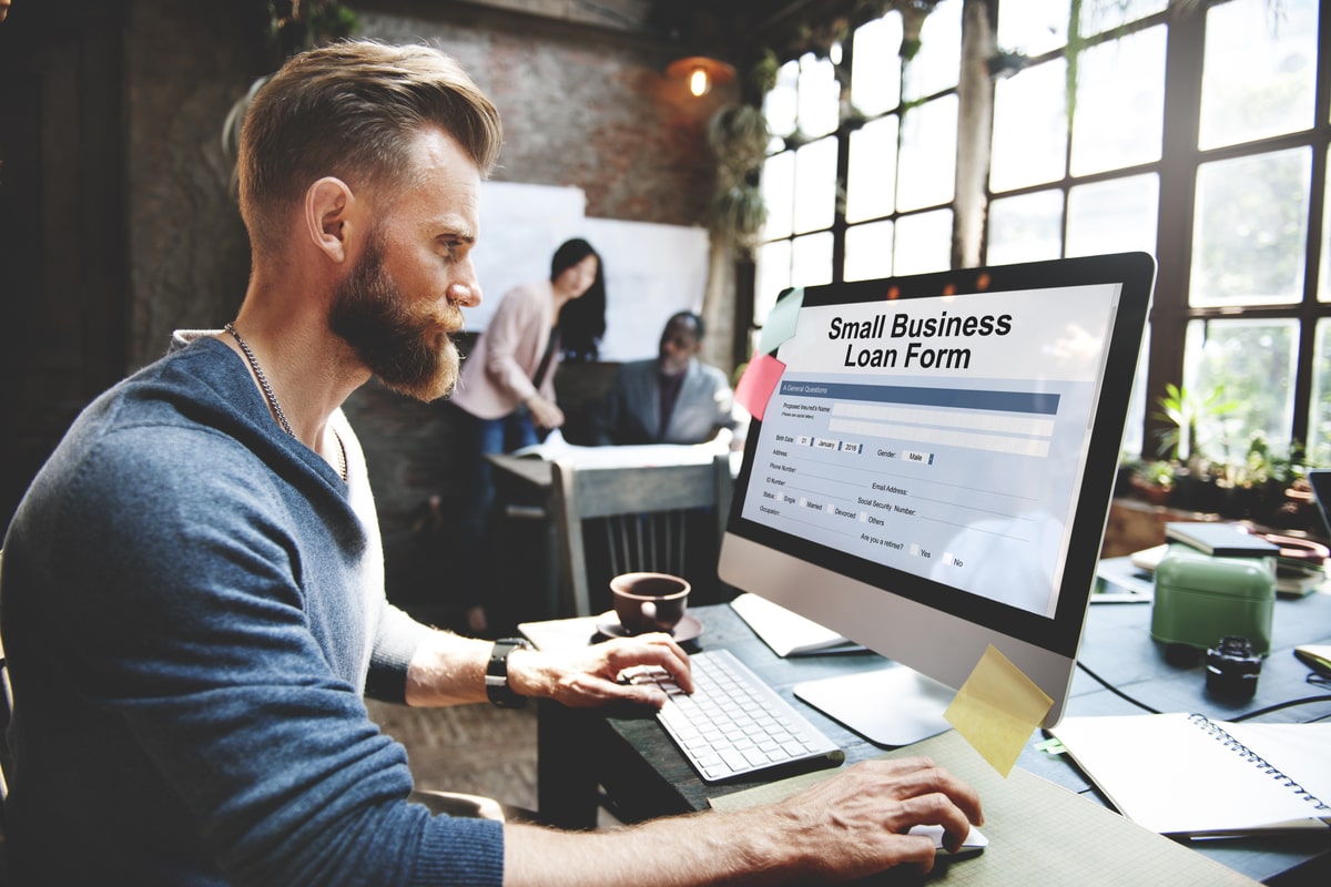 Man applying for a small business loan on a computer.