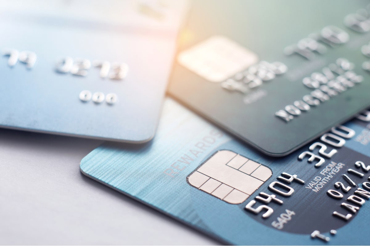 Three credit cards scattered on a table.