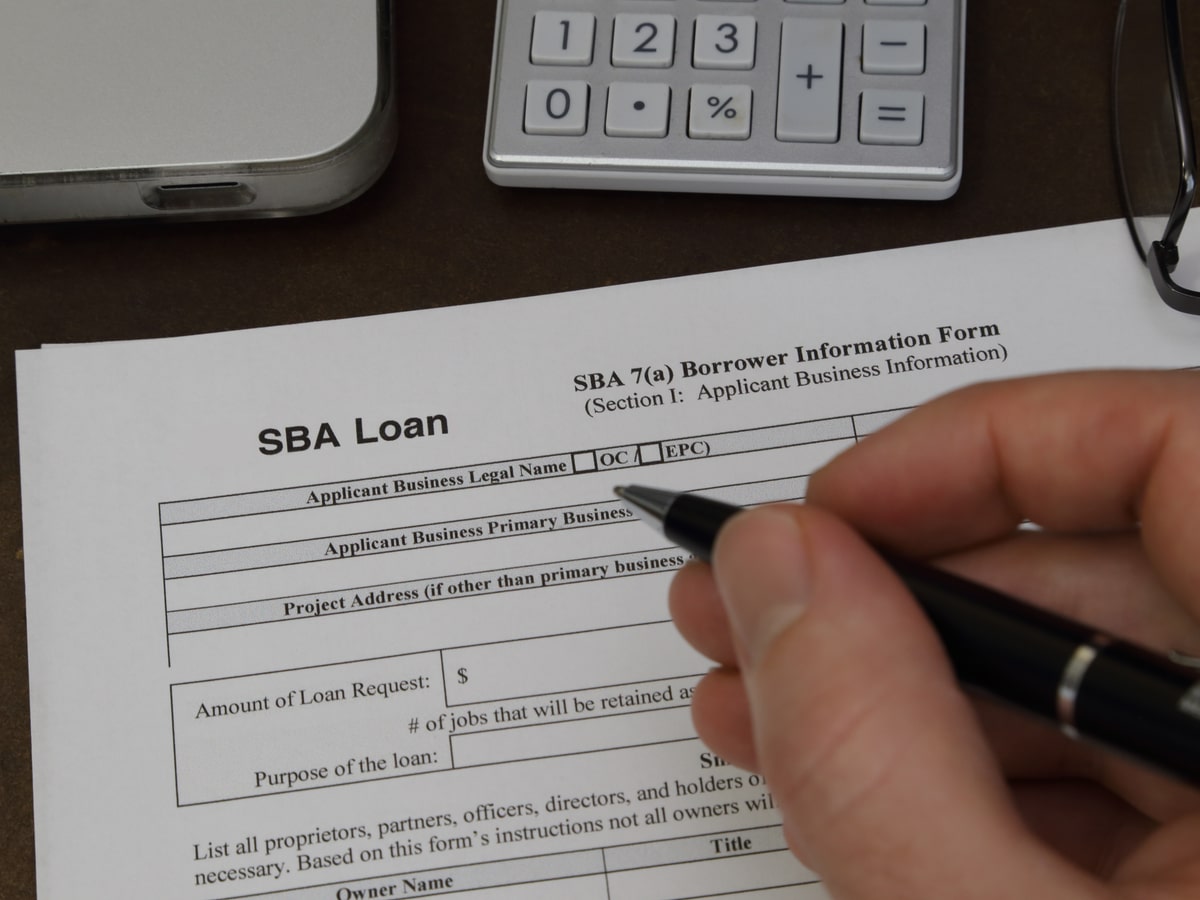 Woman filling out an SBA 7(a) loan application.
